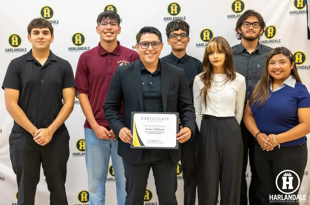 Students participating in a We Can Change IT student program and receiving recognition for their work.